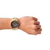 Gold wristwatch on a wrist.