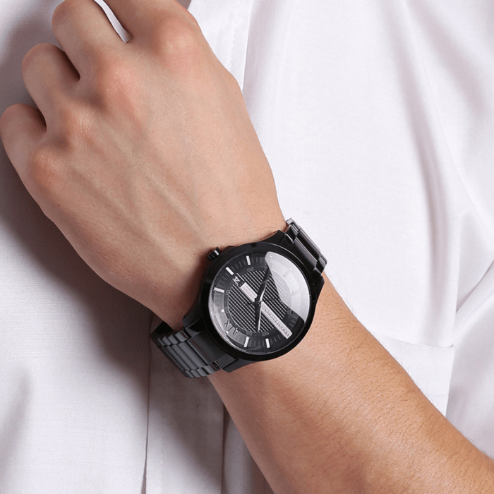 Man's wrist with a black watch.