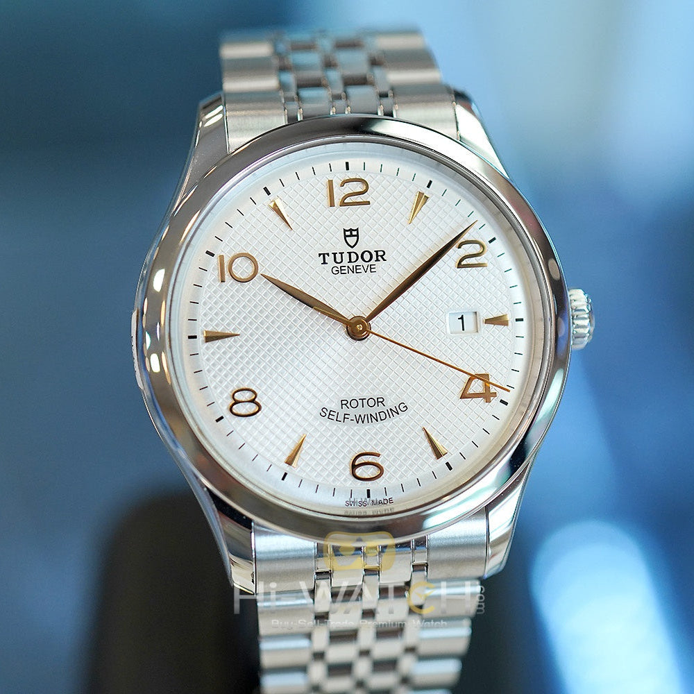 Silver wristwatch with white face.