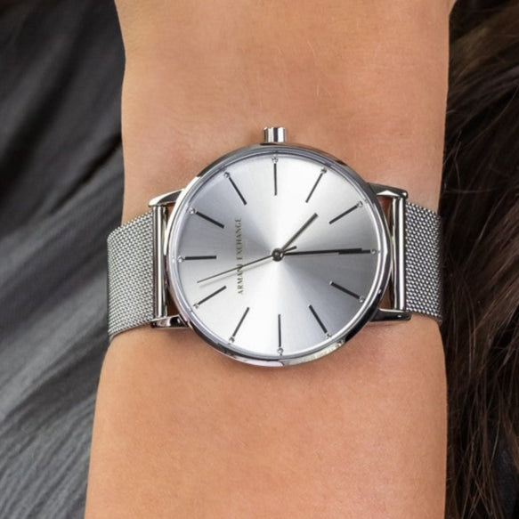 Silver wristwatch on a wrist.