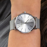 Silver wristwatch on a wrist.