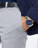 Man wearing a watch, with hand in pocket.
