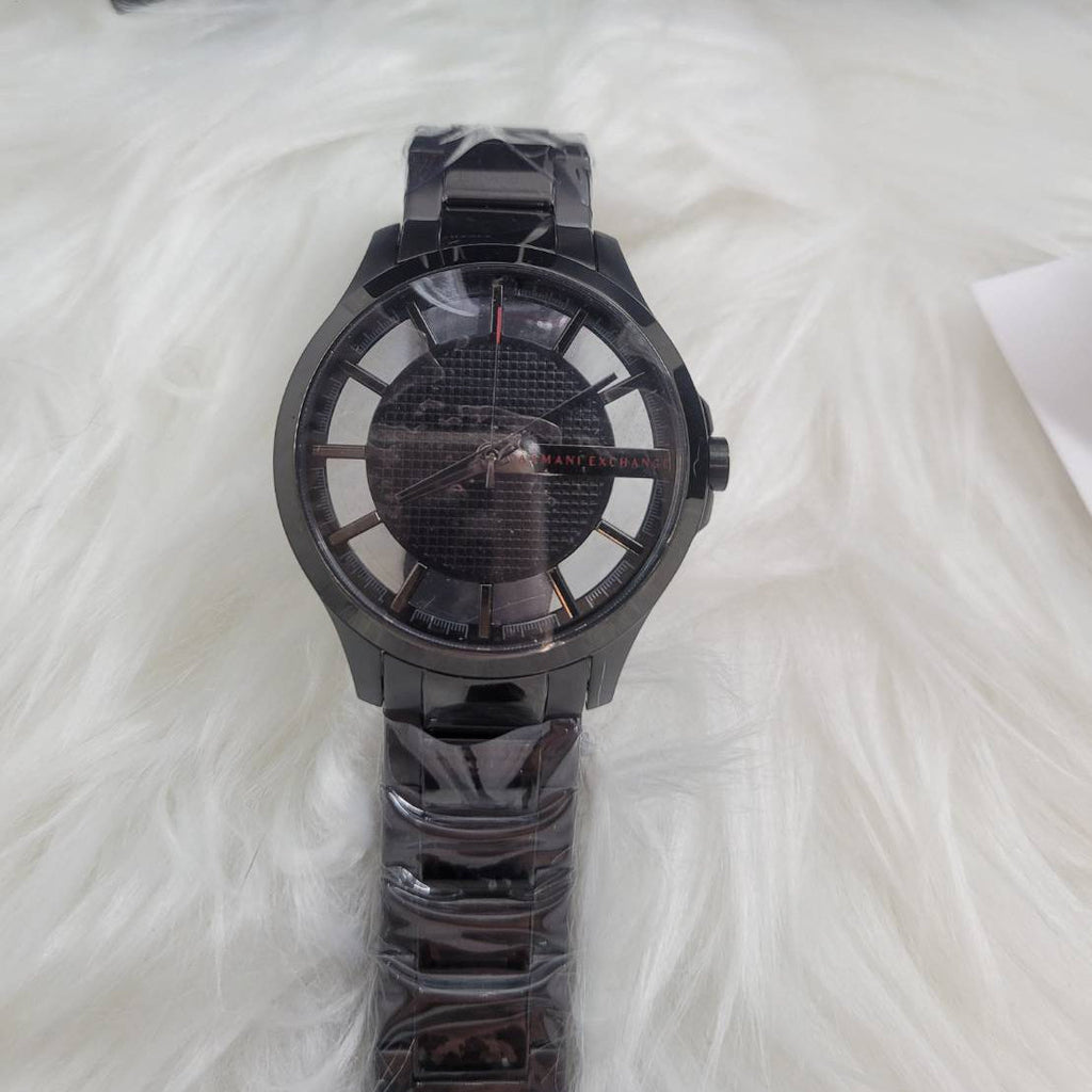 Black wristwatch on white fur.