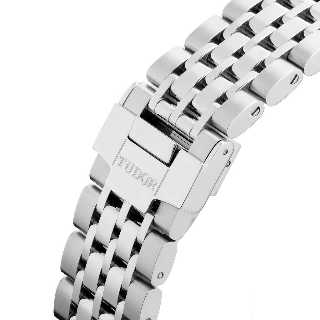 Stainless steel watch band clasp with TUDOR text.