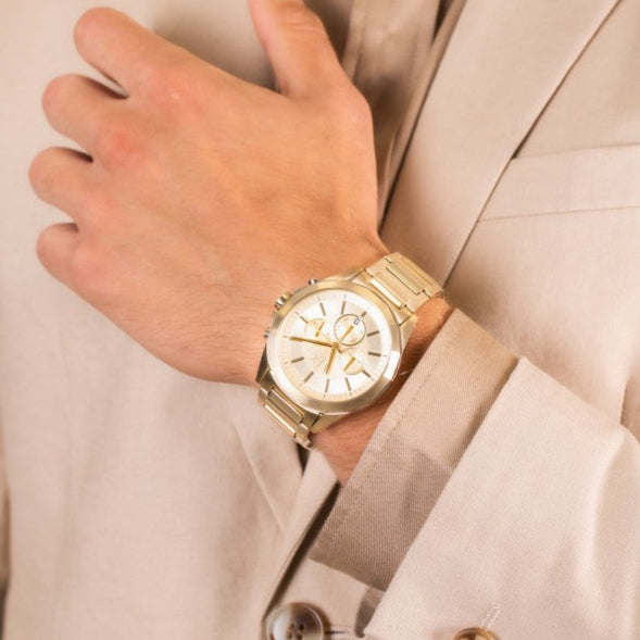Man wearing a gold wristwatch.