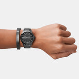 Man's wrist with black watch and bracelet