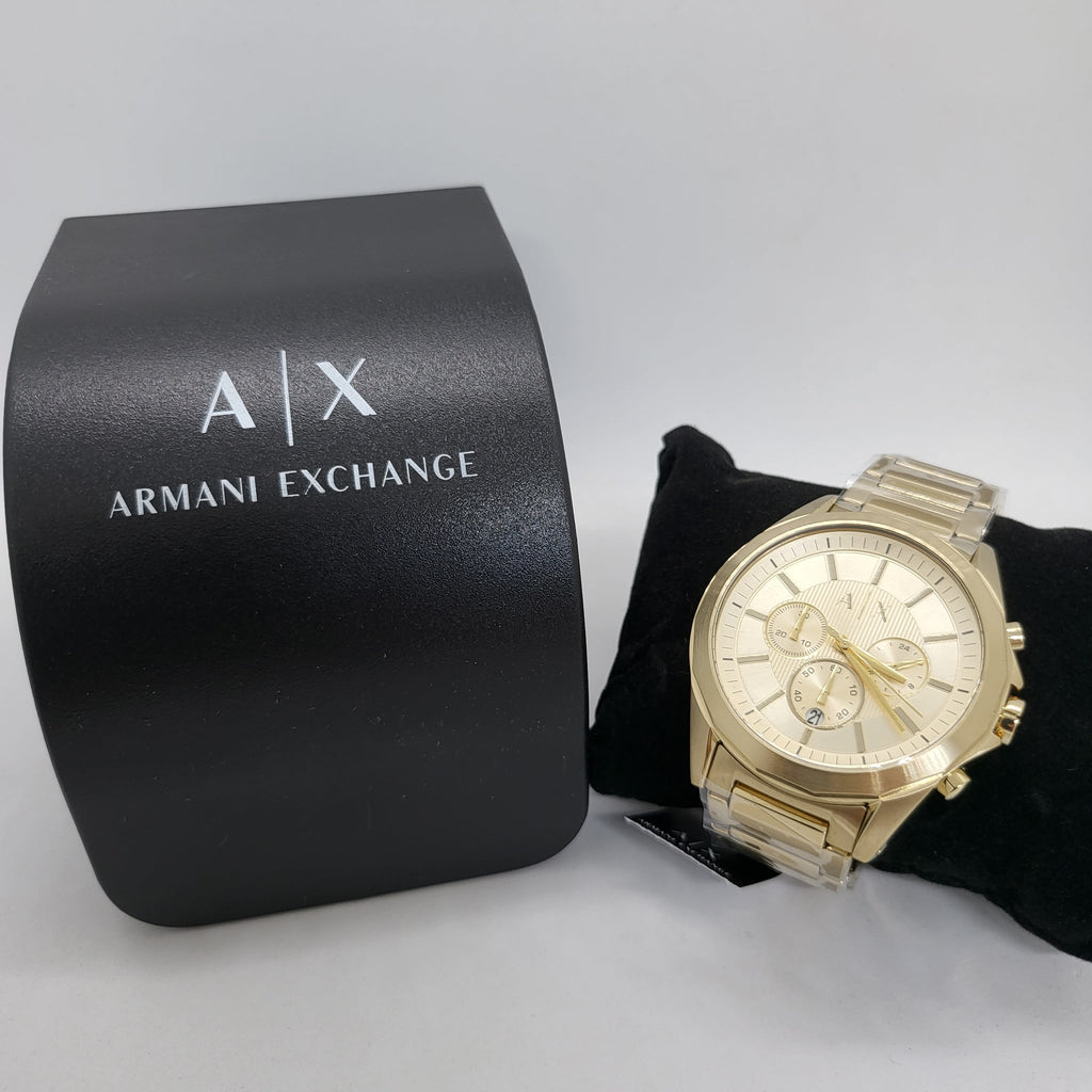 Gold Armani Exchange watch next to its box.