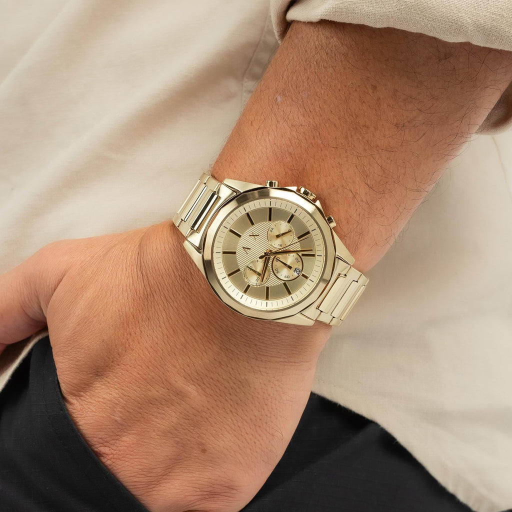 Gold wristwatch on a wrist.