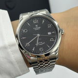 Silver wristwatch on wrist.