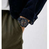 Man wearing a black watch and navy jacket.