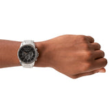 Wrist with silver watch.