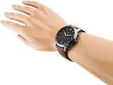 Fossil watch on wrist with brown leather band