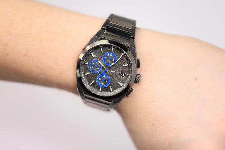 Wrist with a black watch showing time.