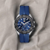 Blue wristwatch on a gray cloth.