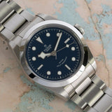Silver wristwatch with blue face.