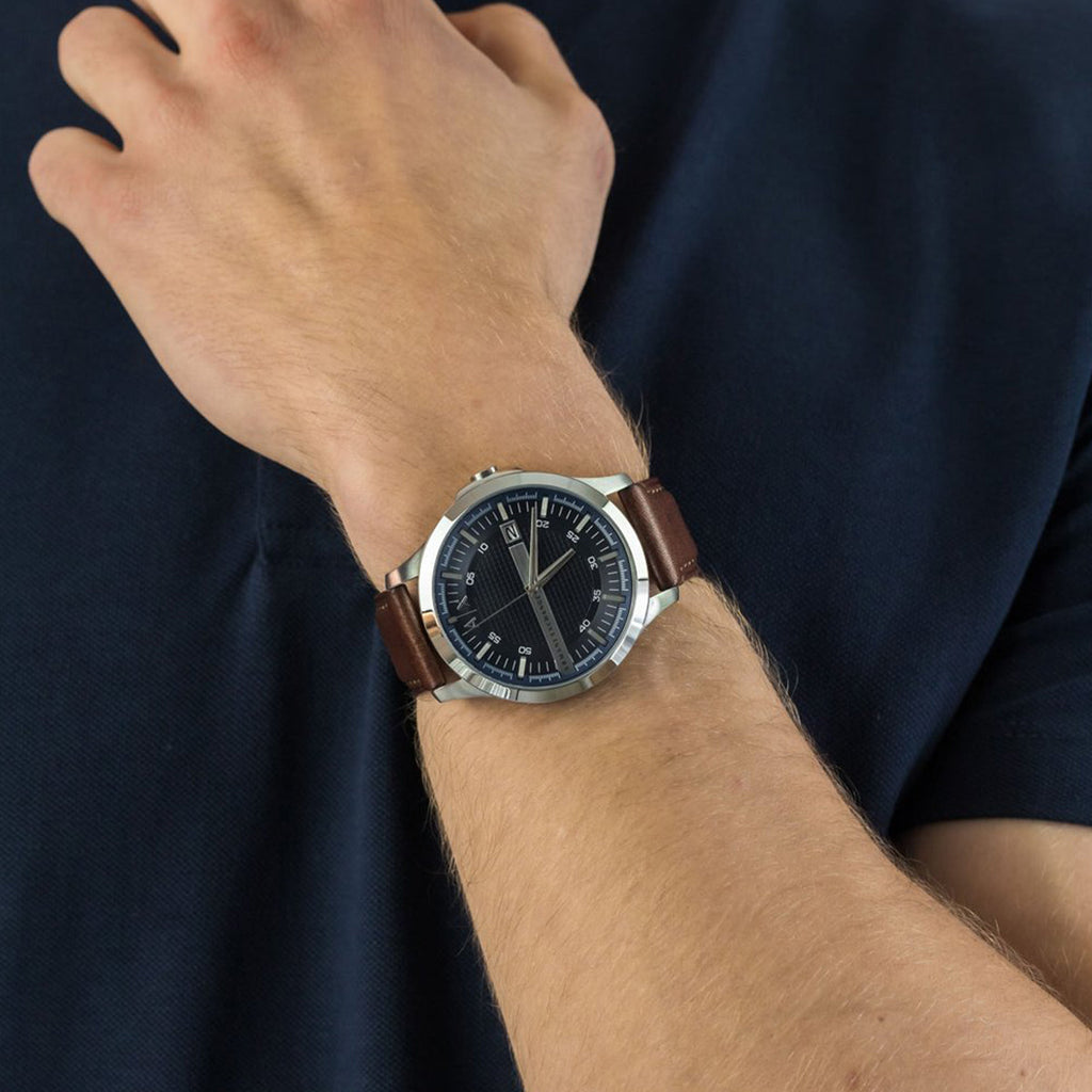 Man wearing a brown leather strap watch