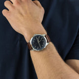 Man wearing a brown leather strap watch