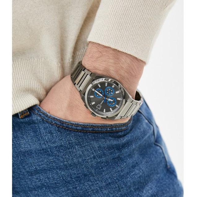 Man wearing a watch with a blue dial.