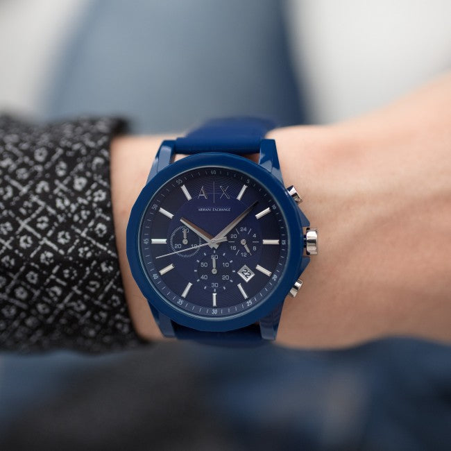 Blue wristwatch on a wrist.