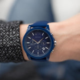 Blue wristwatch on a wrist.