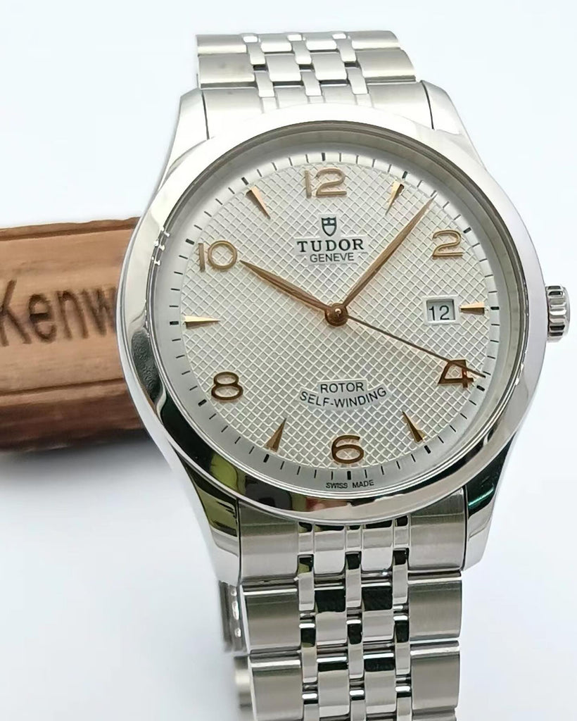 Silver wristwatch with textured face and metal band.