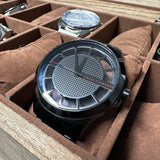 Black Armani Exchange watch in a watch box.
