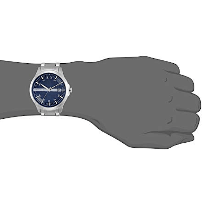 Silver wristwatch on a gray arm.