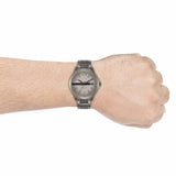 Man's wrist with a silver watch,...