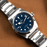 Silver wristwatch with blue face.