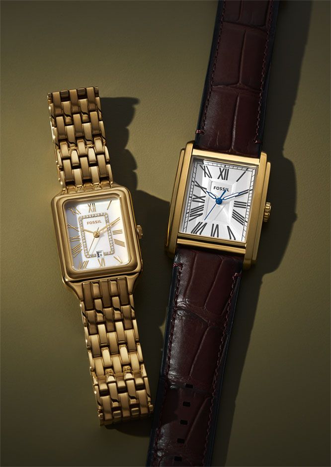 Two gold rectangular wristwatches.