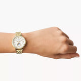 Gold Fossil watch on wrist
