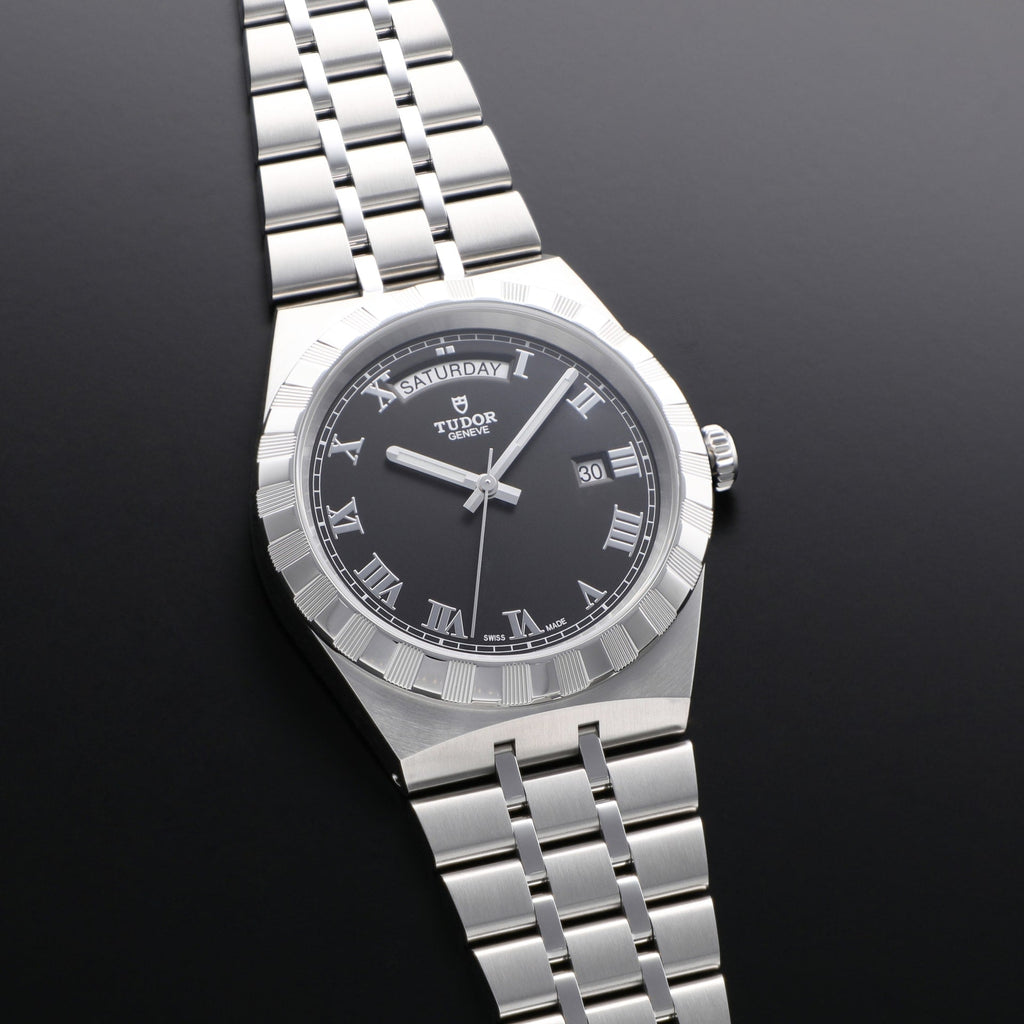 Tudor watch with black face and Roman numerals