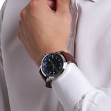 Men's AX2133 watch with brown leather strap on wrist