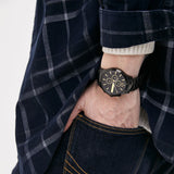 AX2164-2 black watch on wrist in plaid shirt pocket