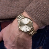 Armani Exchange AX2707 gold watch on wrist