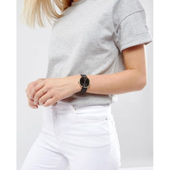 Woman wearing black watch & grey t-shirt
