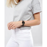 Woman wearing black watch & grey t-shirt