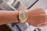 Gold wristwatch on wrist