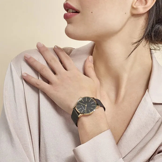Woman wearing gold watch