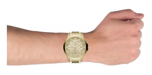 Gold wristwatch on wrist.