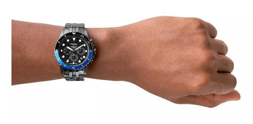 Man's wrist wearing a black and blue watch, product photo MCO50407017792.