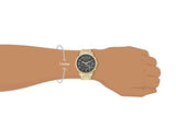 Gold wristwatch on wrist, 7-inch wrist size