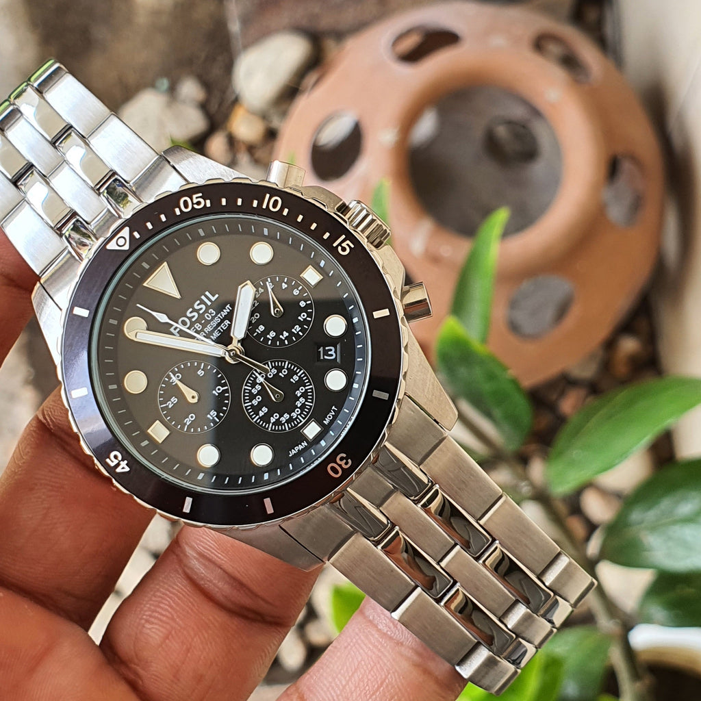 Fossil watch with black face and silver band