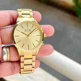 Gold AX watch on hand