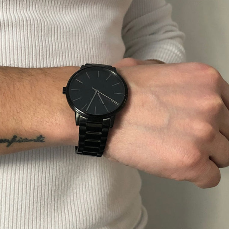 Armani Exchange black watch on wrist
