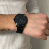Armani Exchange black watch on wrist