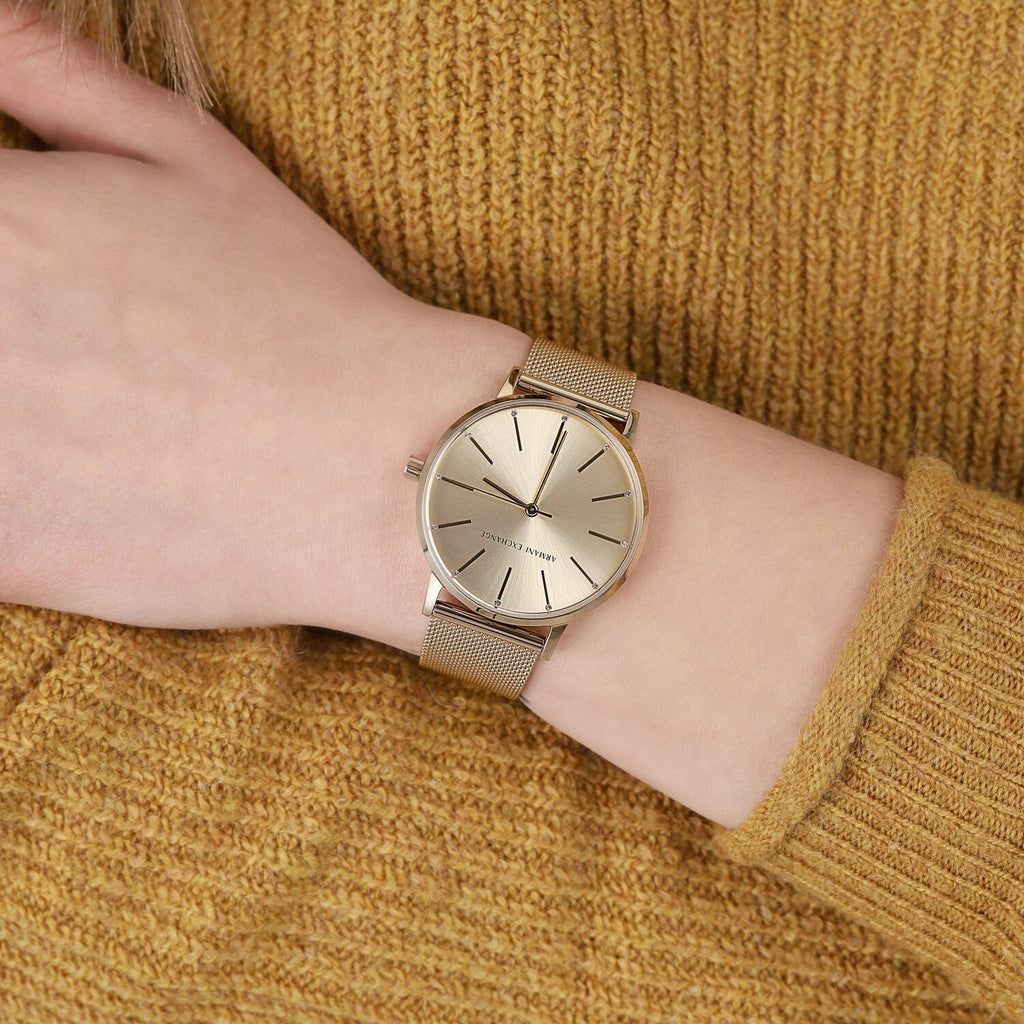 Armani Exchange AX5536 gold watch on wrist