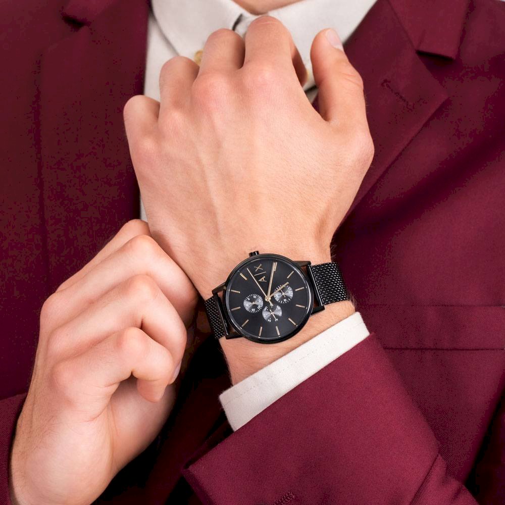 Man wearing black AX watch, maroon suit.