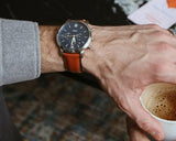 Fossil FS5791 men's watch on wrist with coffee.