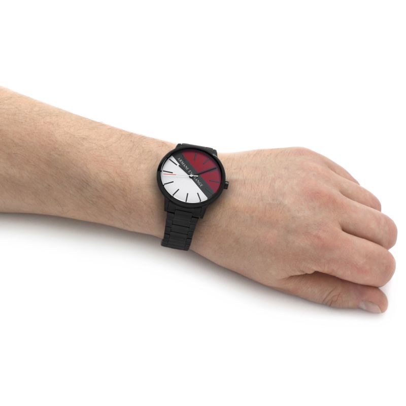 Black watch with red and white face on wrist